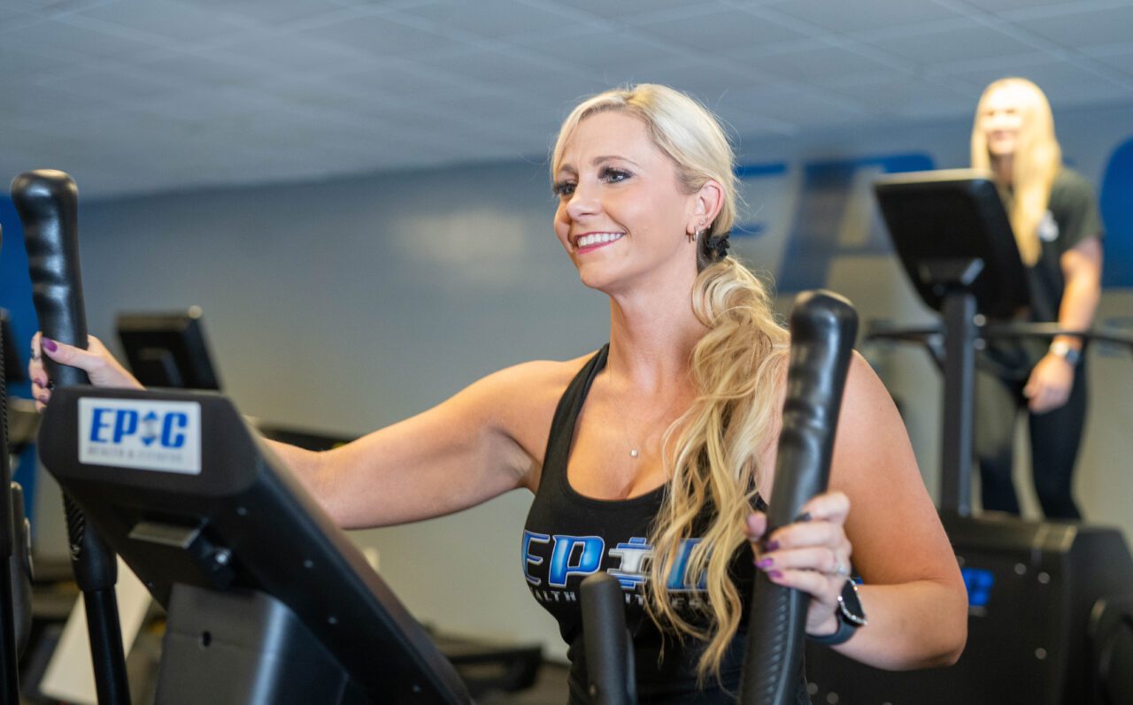 Woman beginning her fitness journey with cardio workout at Epic Fitness gym in New Hampshire, highlighting personal training, wellness, and a motivating workout environment.